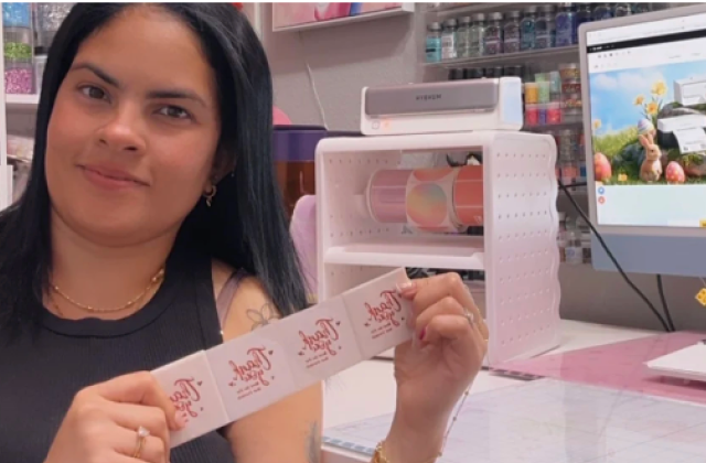 Creator demonstrating printed labels in a craft room